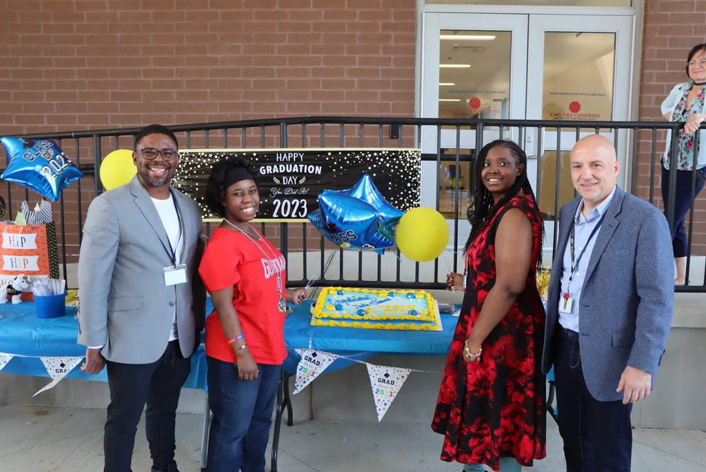 Principal Russell & Superintendent Papouras join Jackie and Diamond as they cut their cake.